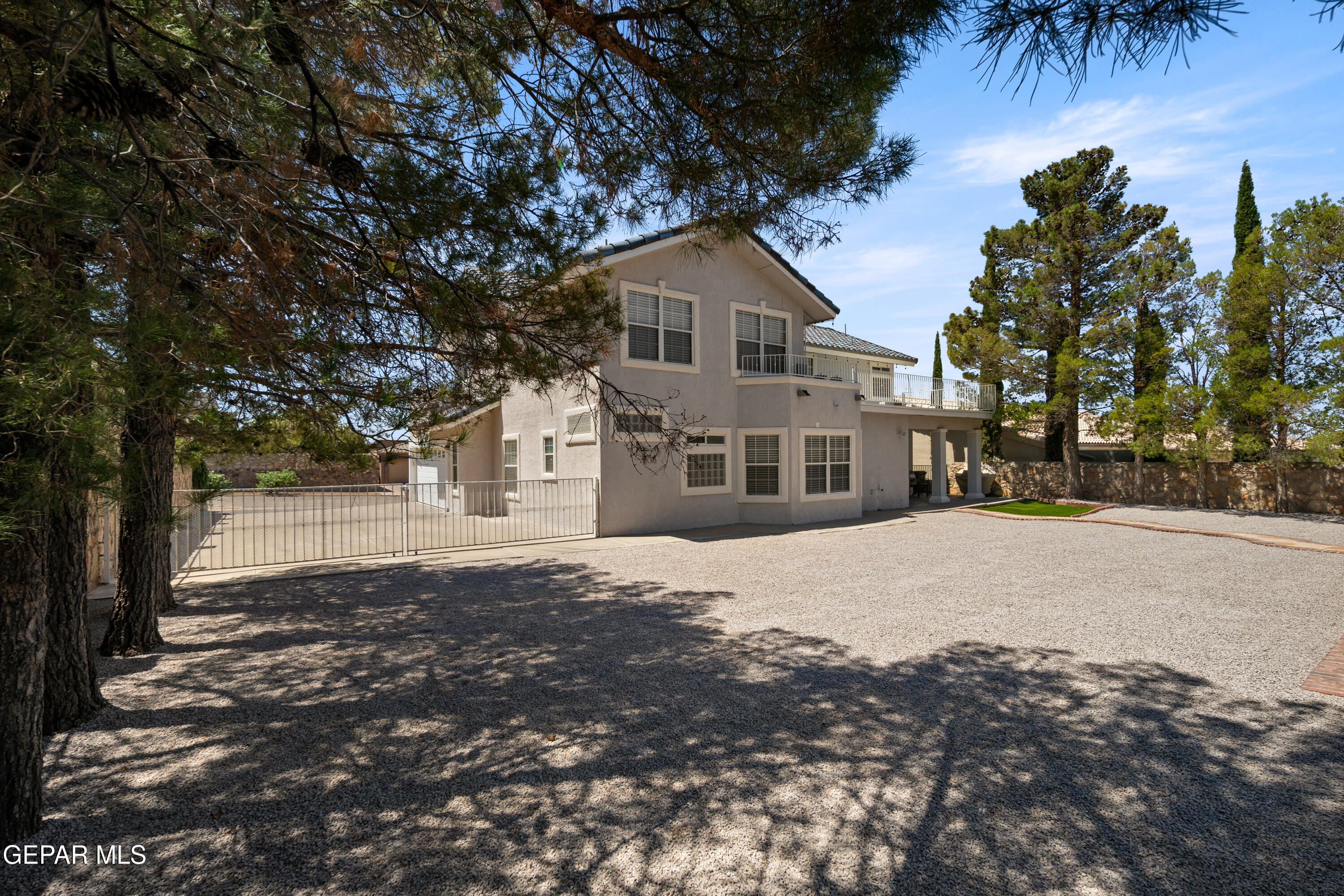 6705 Pearl Ridge Drive El Paso, TX 79912 - Photo 56 of 58 a front view of a house with a yard and garage