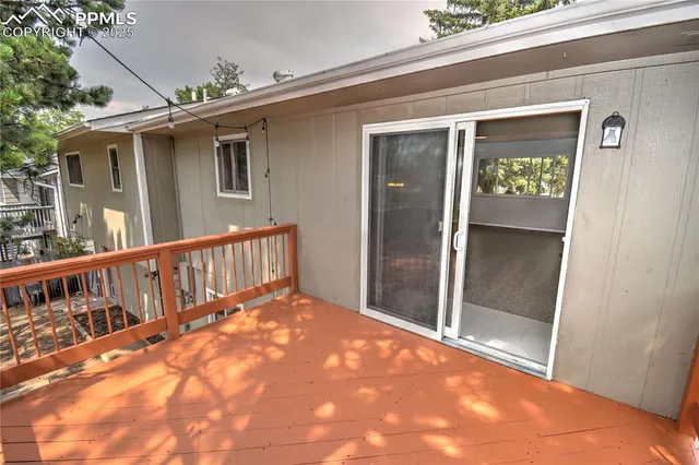 a balcony with wooden floor and outdoor seating