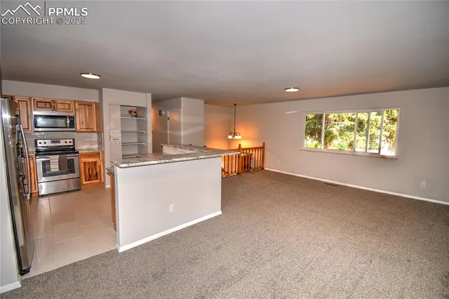 a kitchen with stainless steel appliances a refrigerator and a stove top oven