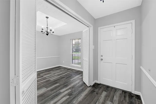 a view of empty room with wooden floor and fireplace