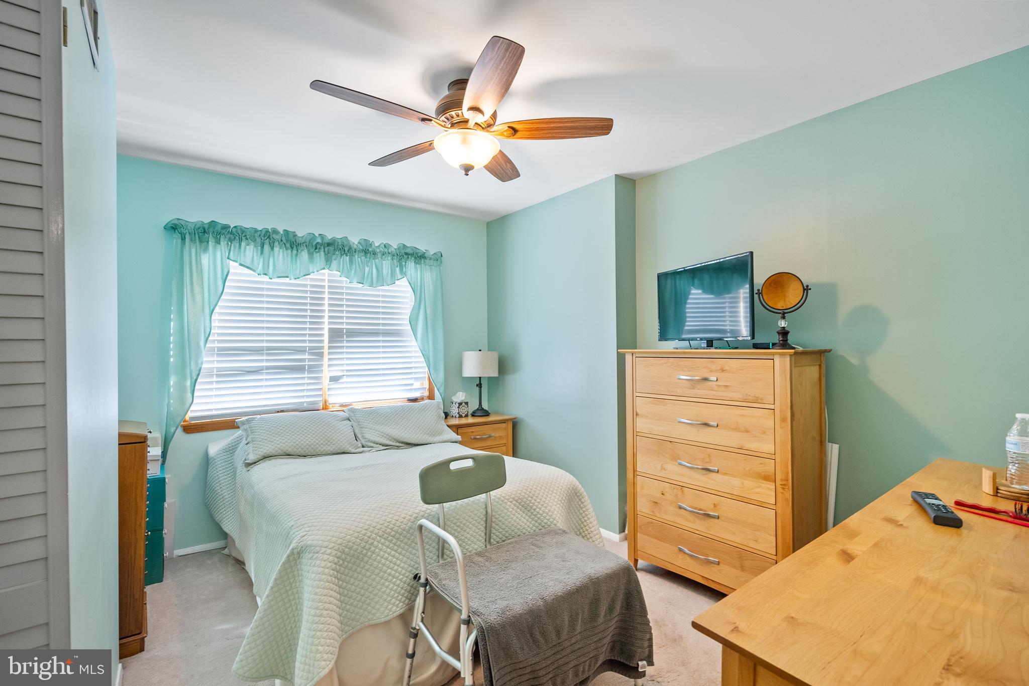 3313 Edgemont Street Philadelphia, PA 19134 - Photo 11 of 22 a bedroom with a bed and a chandelier