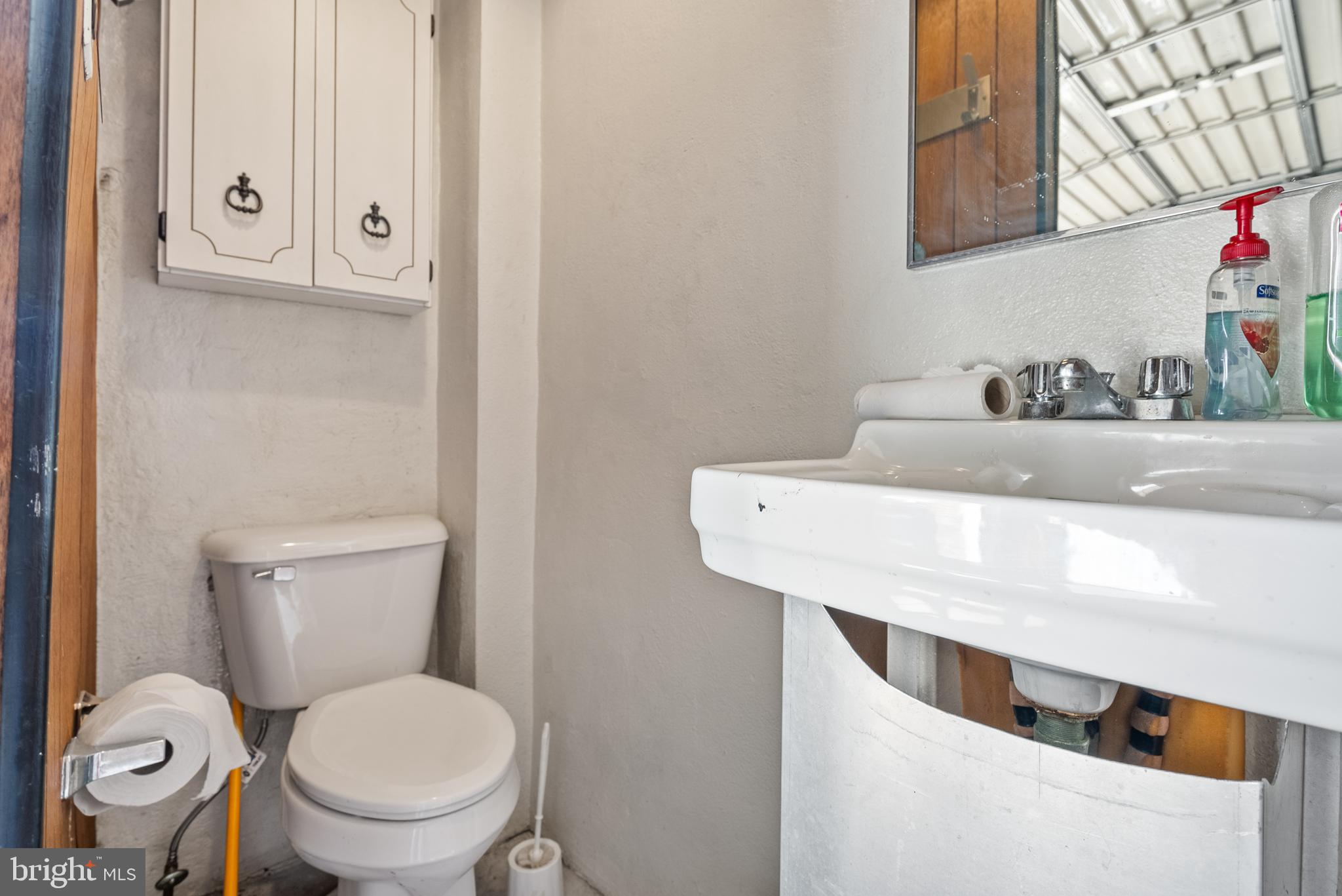 3313 Edgemont Street Philadelphia, PA 19134 - Photo 22 of 22 a bathroom with a toilet sink and mirror
