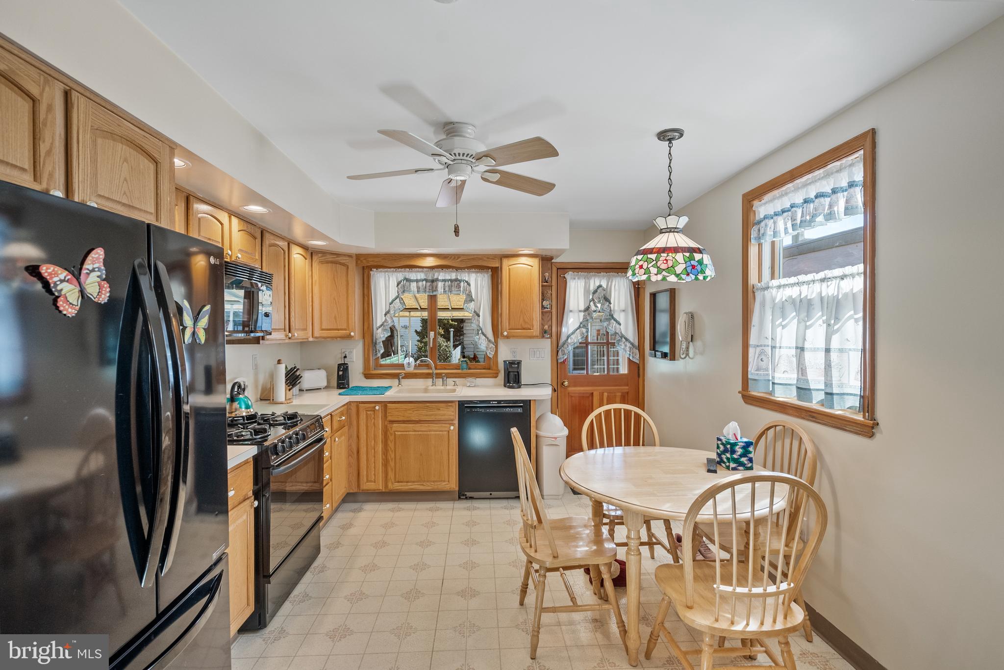 3313 Edgemont Street Philadelphia, PA 19134 - Photo 3 of 22 a large kitchen with stainless steel appliances granite countertop a stove a refrigerator a kitchen island a table and chairs