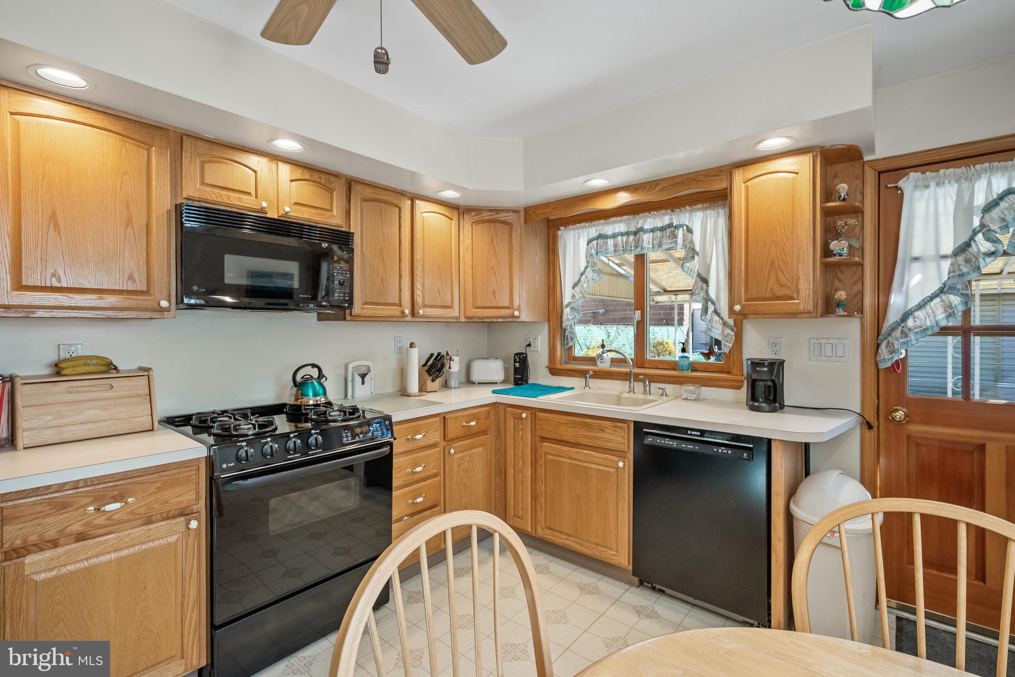 3313 Edgemont Street Philadelphia, PA 19134 - Photo 4 of 22 a kitchen with stainless steel appliances a stove sink microwave and window