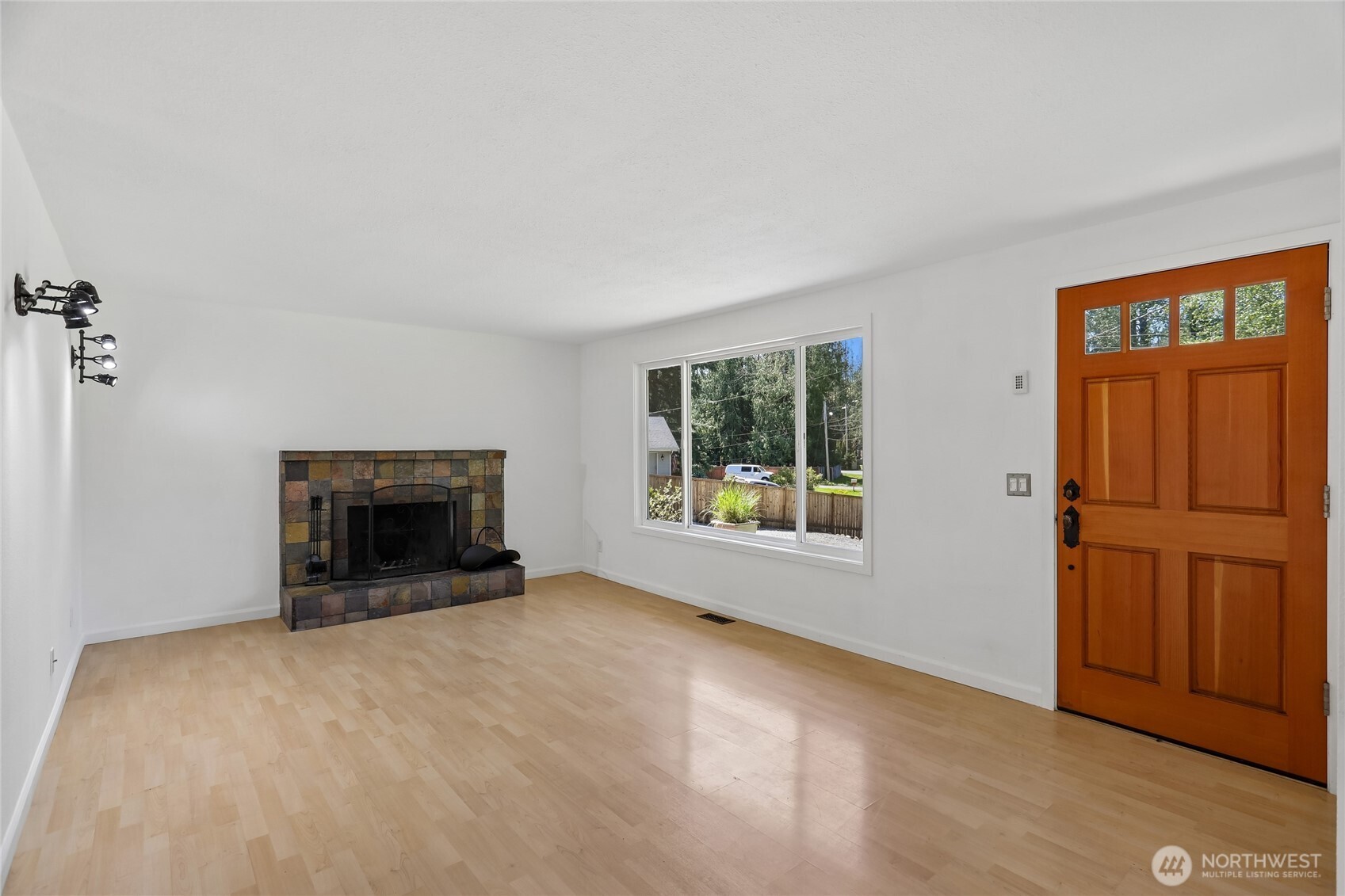 28601 Southeast 225th Street Maple Valley, WA 98038 - Photo 5 of 40 an empty room with windows and fireplace