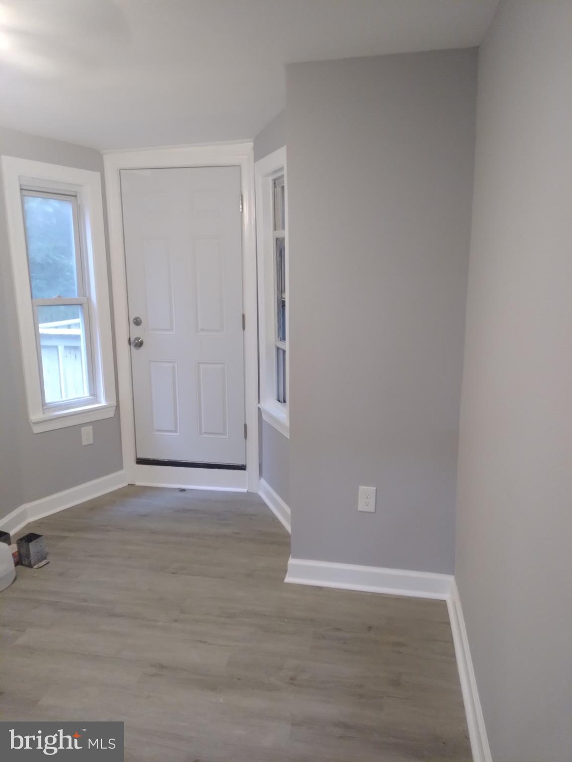 3957 Wallace Street Philadelphia, PA 19104 - Photo 5 of 12 an empty room with wooden floor and windows