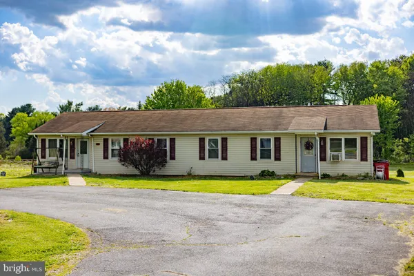 a view of a house with swimming pool and a yard