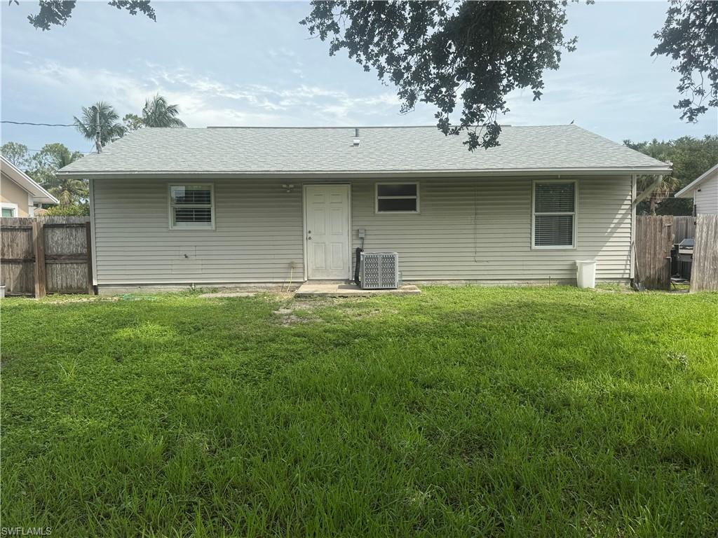 5422 Hardee Street Naples, FL 34113 - Photo 12 of 16 a front view of a house with a garden