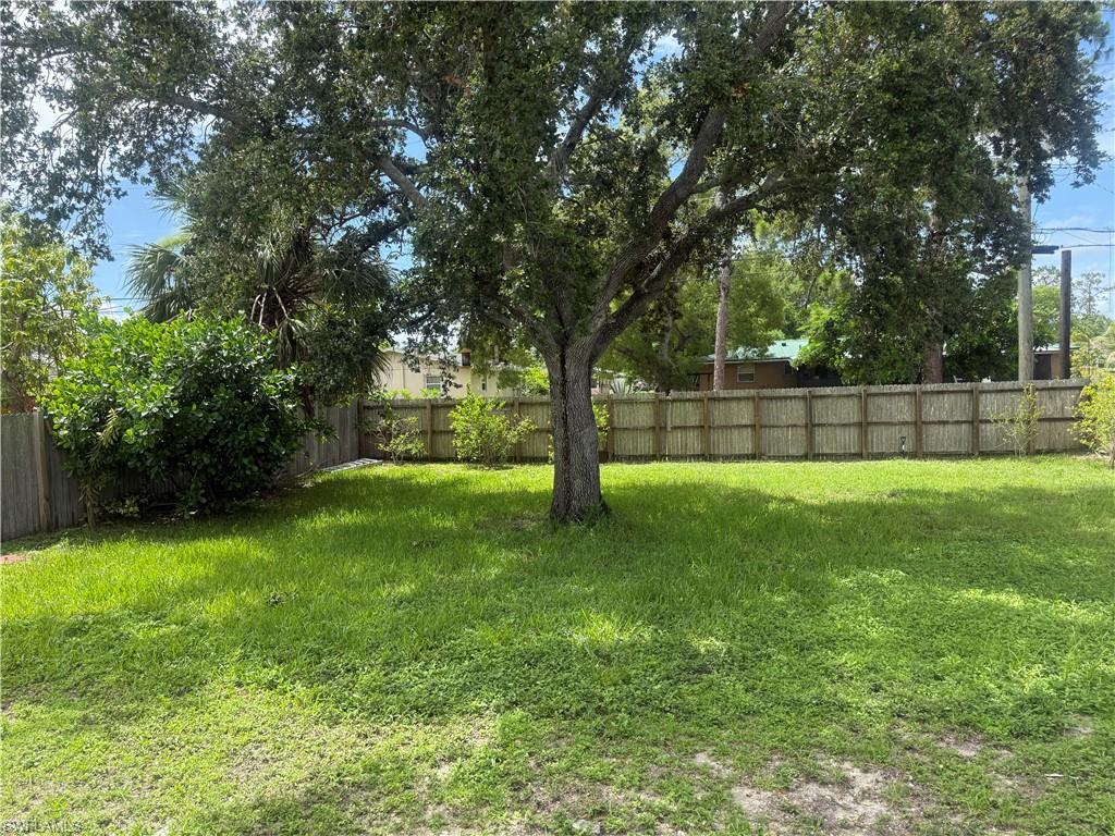 5422 Hardee Street Naples, FL 34113 - Photo 14 of 16 a view of yard with trees in the background