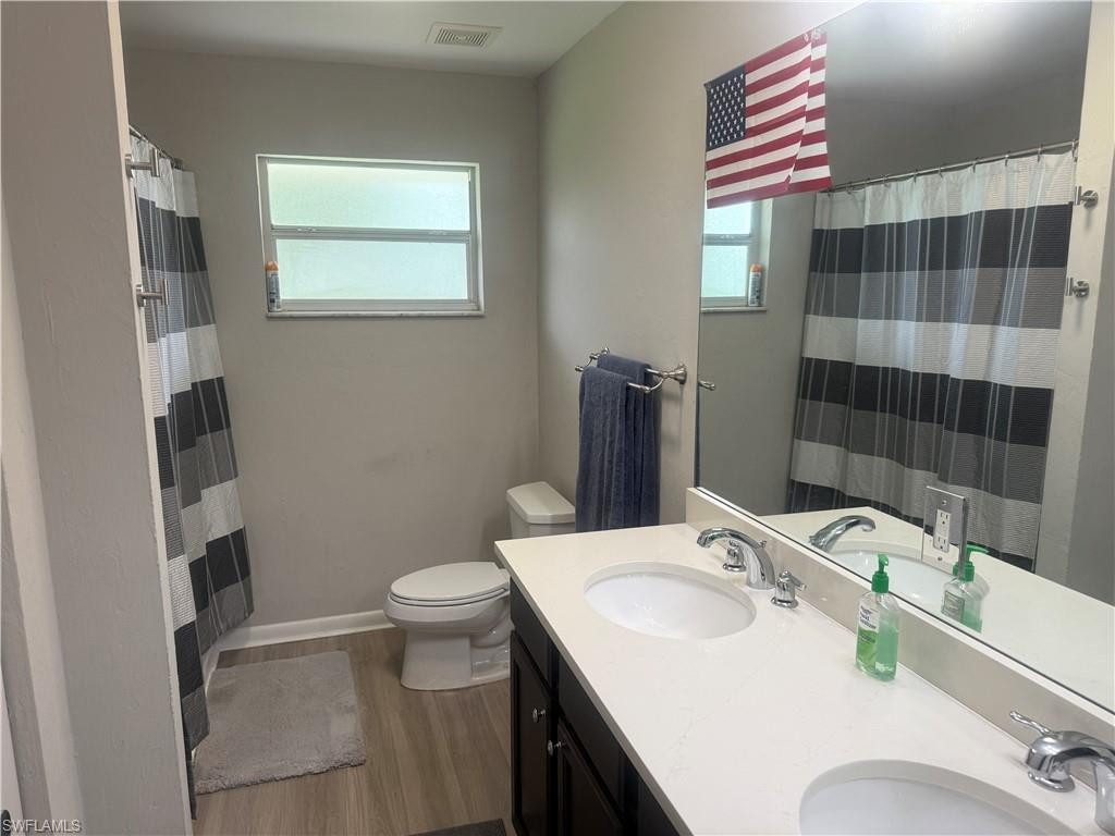 5422 Hardee Street Naples, FL 34113 - Photo 5 of 16 a bathroom with a sink toilet and shower