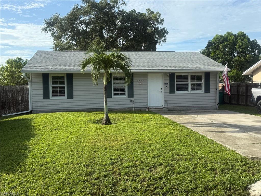 5422 Hardee Street Naples, FL 34113 - Photo 9 of 16 a front view of a house with garden