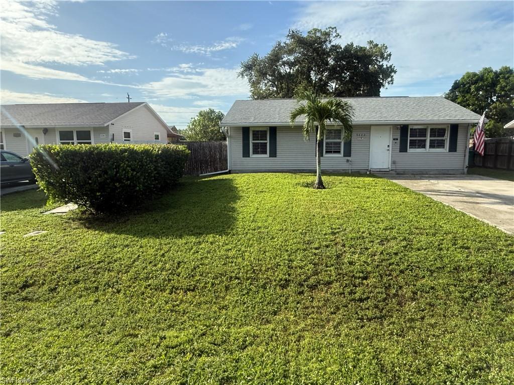 5422 Hardee Street Naples, FL 34113 - Photo 10 of 16 a front view of a house with a garden and porch