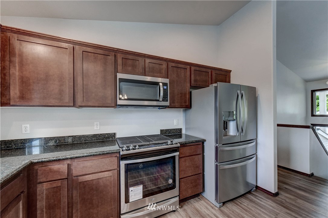 6605 Cady Road Everett, WA 98203 - Photo 11 of 26 a kitchen with granite countertop a refrigerator stove and microwave