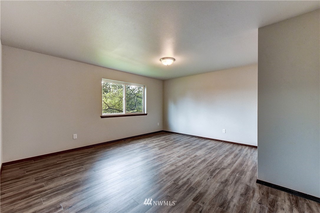 6605 Cady Road Everett, WA 98203 - Photo 18 of 26 an empty room with wooden floor windows and closet