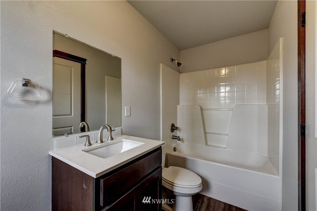 6605 Cady Road Everett, WA 98203 - Photo 19 of 26 a bathroom with a sink toilet a mirror and shower
