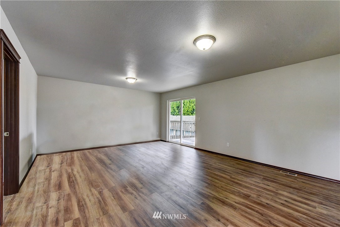 6605 Cady Road Everett, WA 98203 - Photo 22 of 26 a view of an empty room with wooden floor and a window