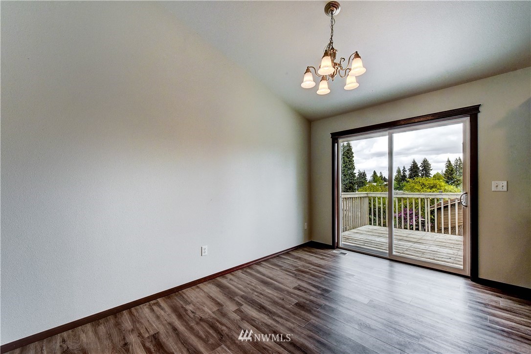 6605 Cady Road Everett, WA 98203 - Photo 7 of 26 a view of an empty room with wooden floor and a window