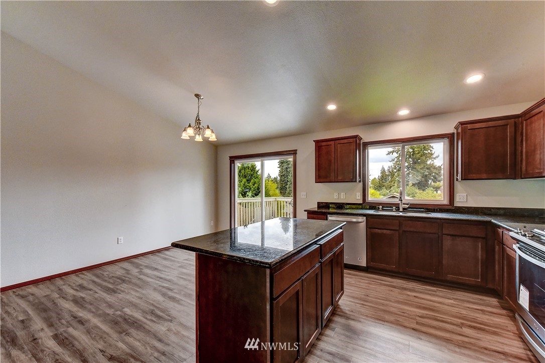 6605 Cady Road Everett, WA 98203 - Photo 9 of 26 a kitchen with granite countertop stove top oven and cabinets