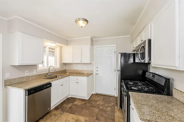 a kitchen that has a sink and a stove
