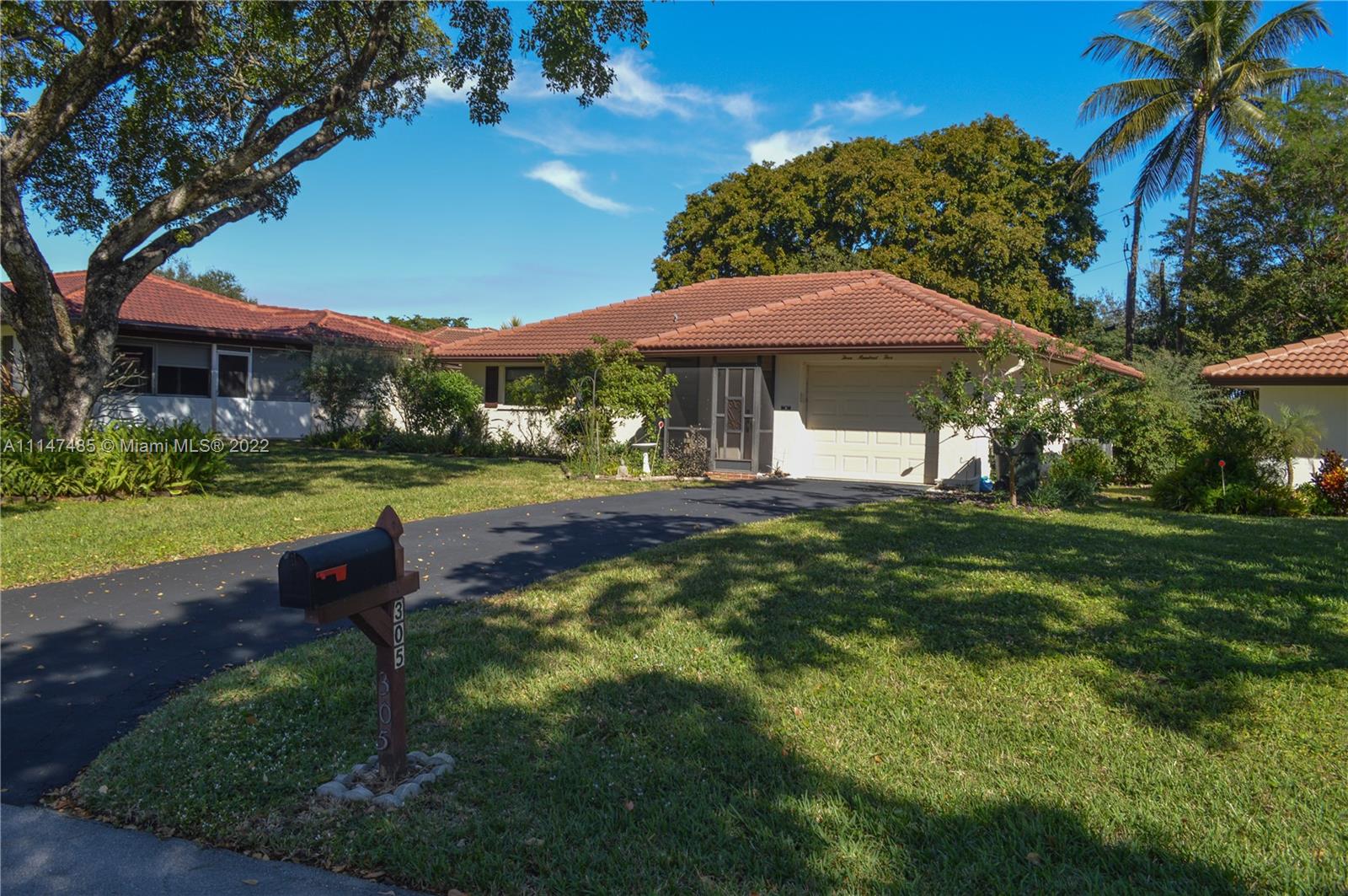 305 Northwest 42nd Street Boca Raton, FL 33431 - Photo 1 of 23 a view of a park with a table and chairs under an umbrella
