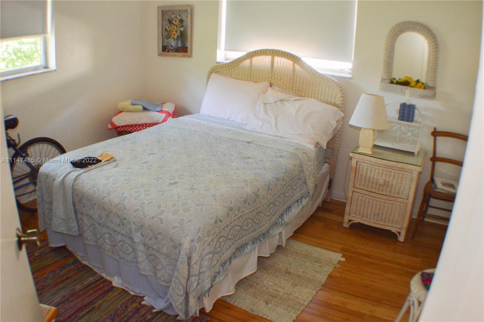 305 Northwest 42nd Street Boca Raton, FL 33431 - Photo 11 of 23 a bed sitting in a bedroom next to a window