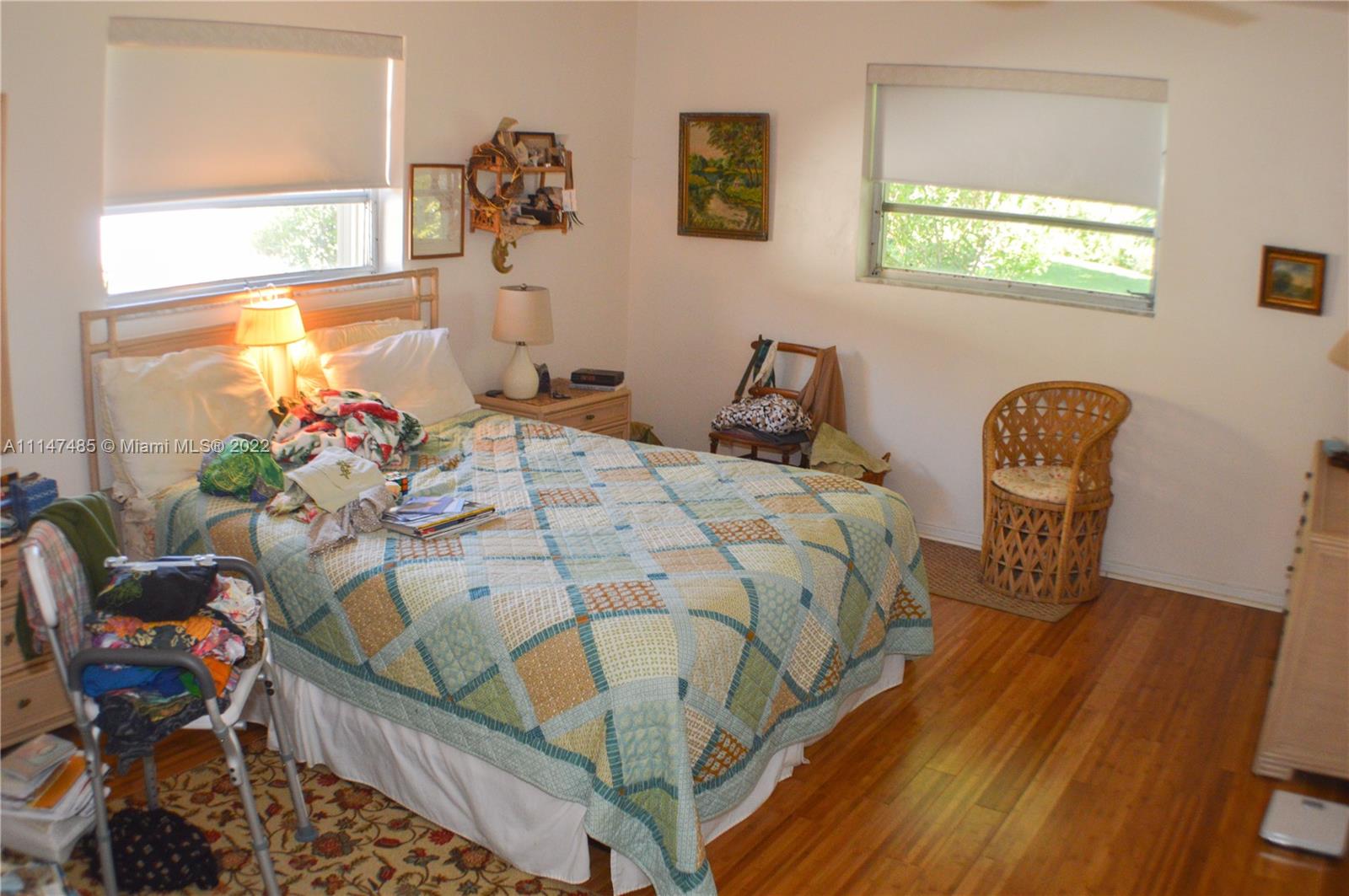 305 Northwest 42nd Street Boca Raton, FL 33431 - Photo 13 of 23 a bedroom with a bed and a chair