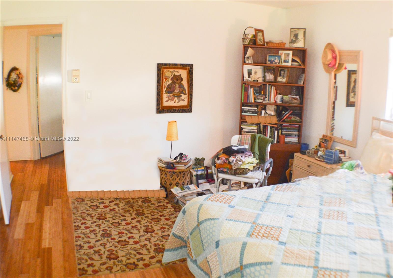 305 Northwest 42nd Street Boca Raton, FL 33431 - Photo 14 of 23 a bed room with a bed and a book shelf