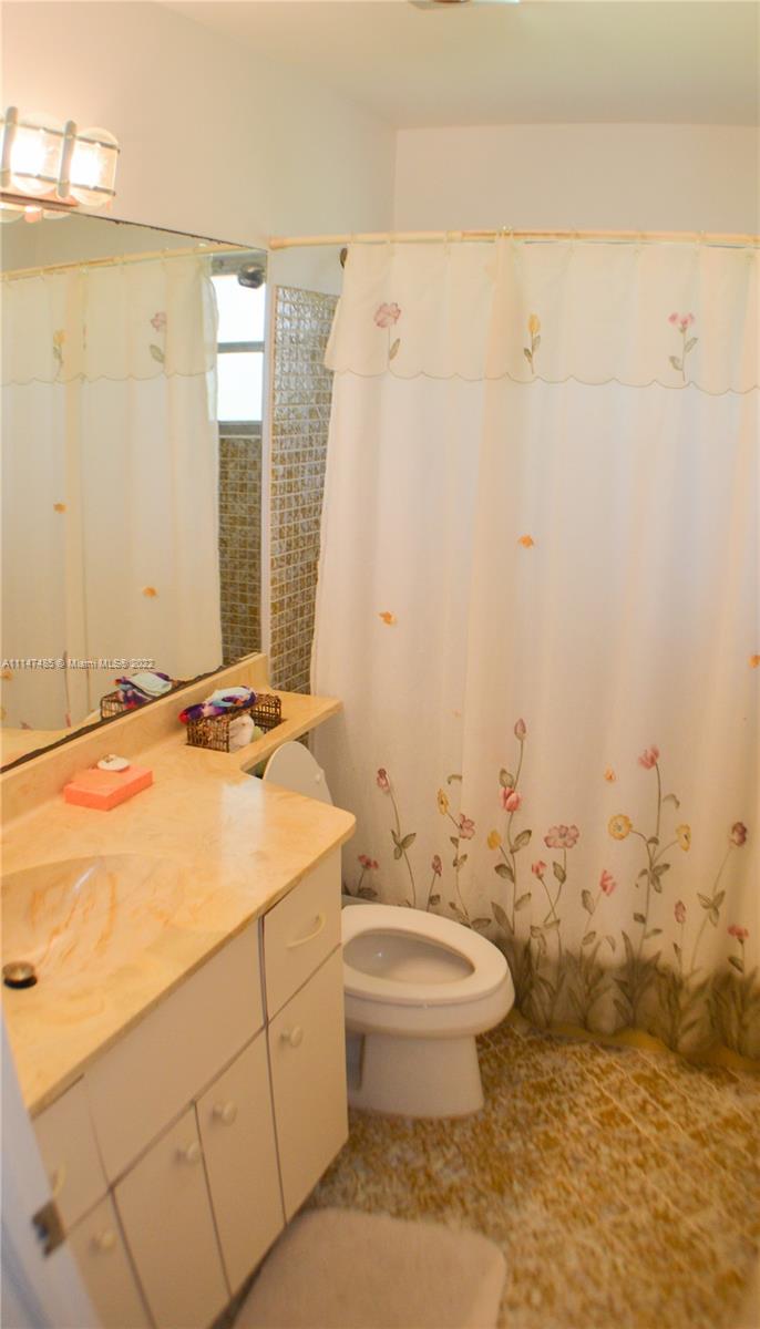305 Northwest 42nd Street Boca Raton, FL 33431 - Photo 15 of 23 a bathroom with a sink a toilet and shower