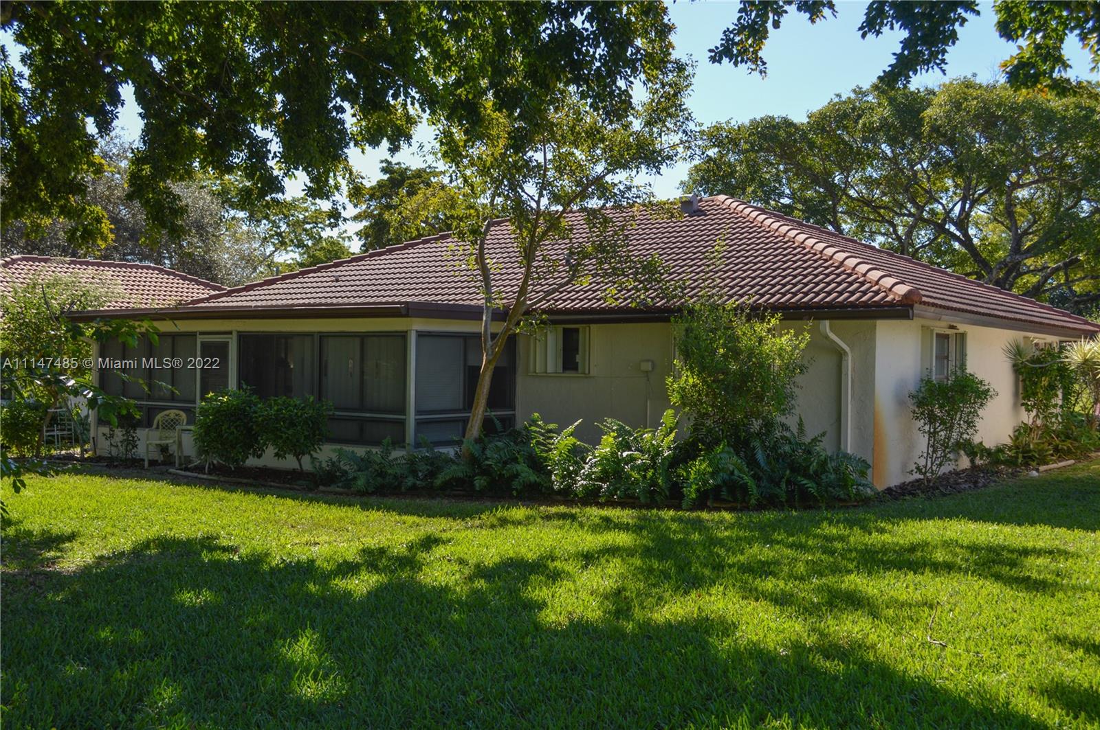 305 Northwest 42nd Street Boca Raton, FL 33431 - Photo 16 of 23 a front view of a house with garden