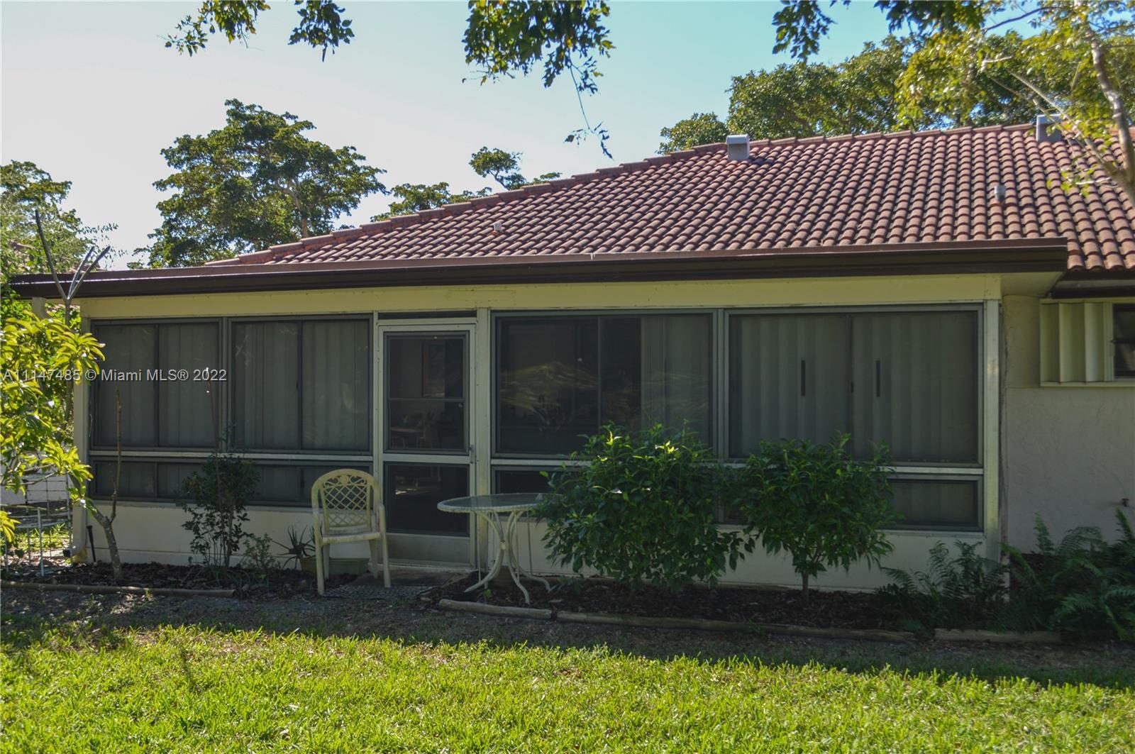 305 Northwest 42nd Street Boca Raton, FL 33431 - Photo 17 of 23 a front view of a house with a yard
