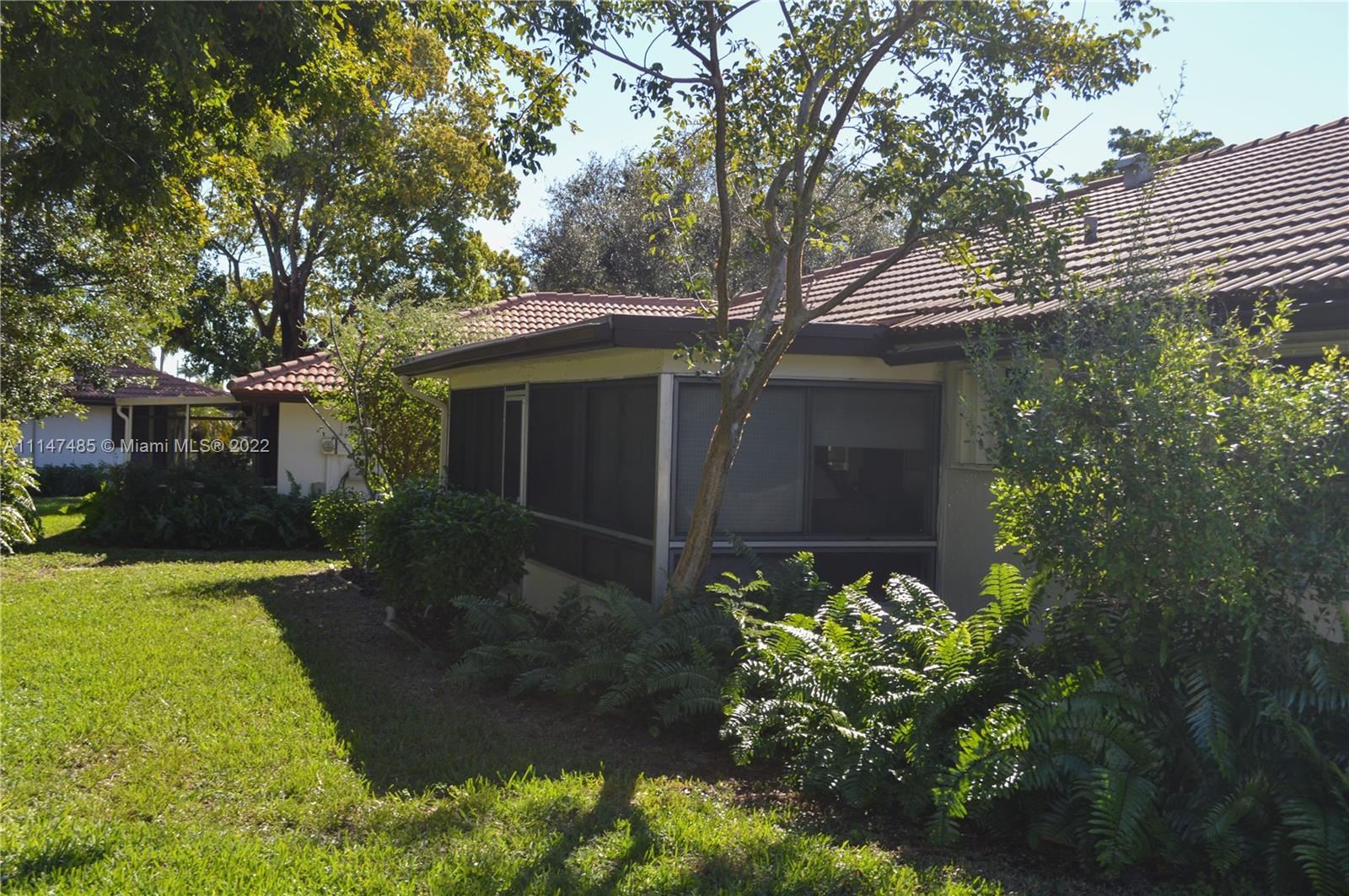 305 Northwest 42nd Street Boca Raton, FL 33431 - Photo 20 of 23 a front view of a house with garden