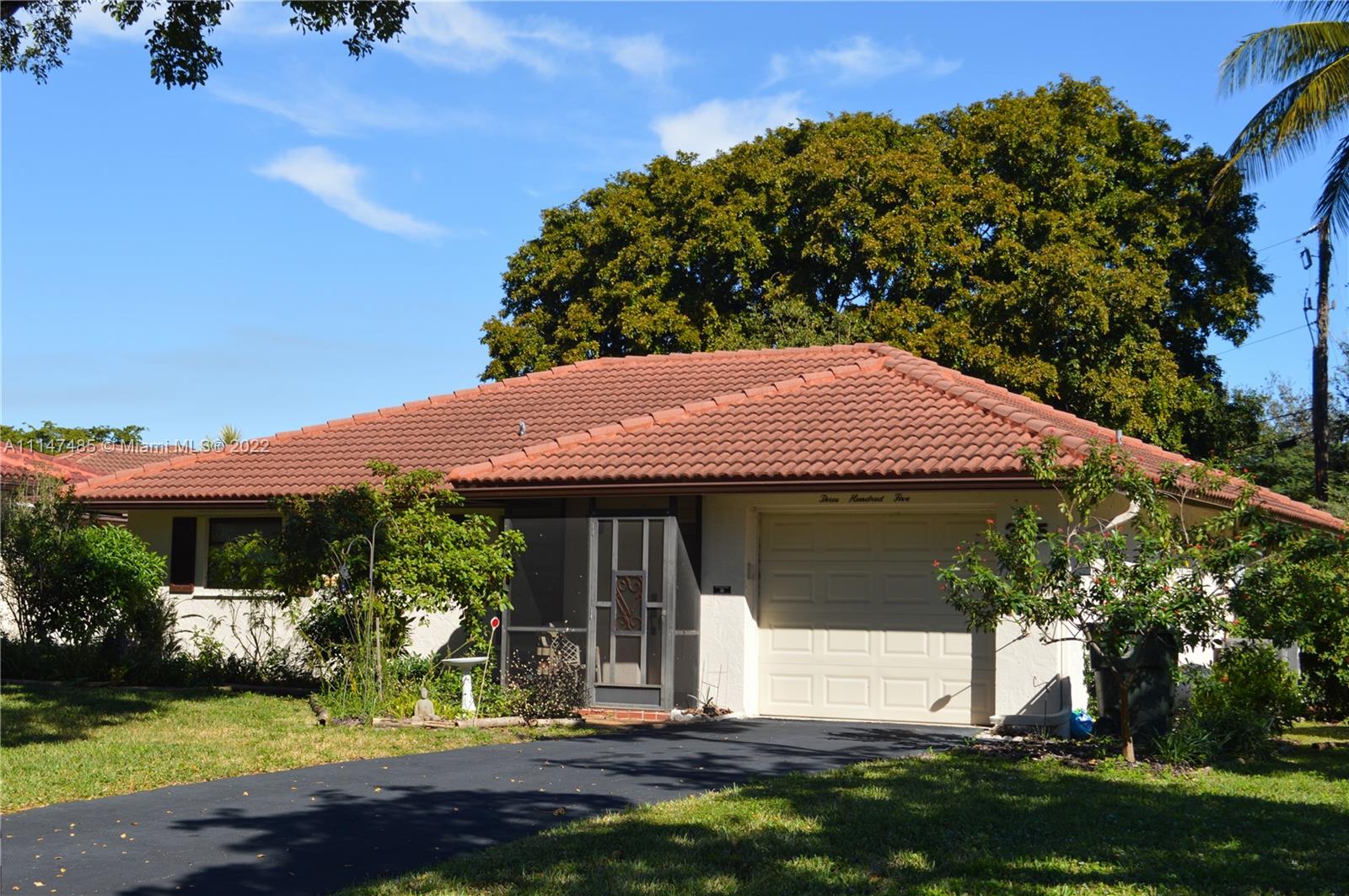 305 Northwest 42nd Street Boca Raton, FL 33431 - Photo 3 of 23 a front view of a house with a yard