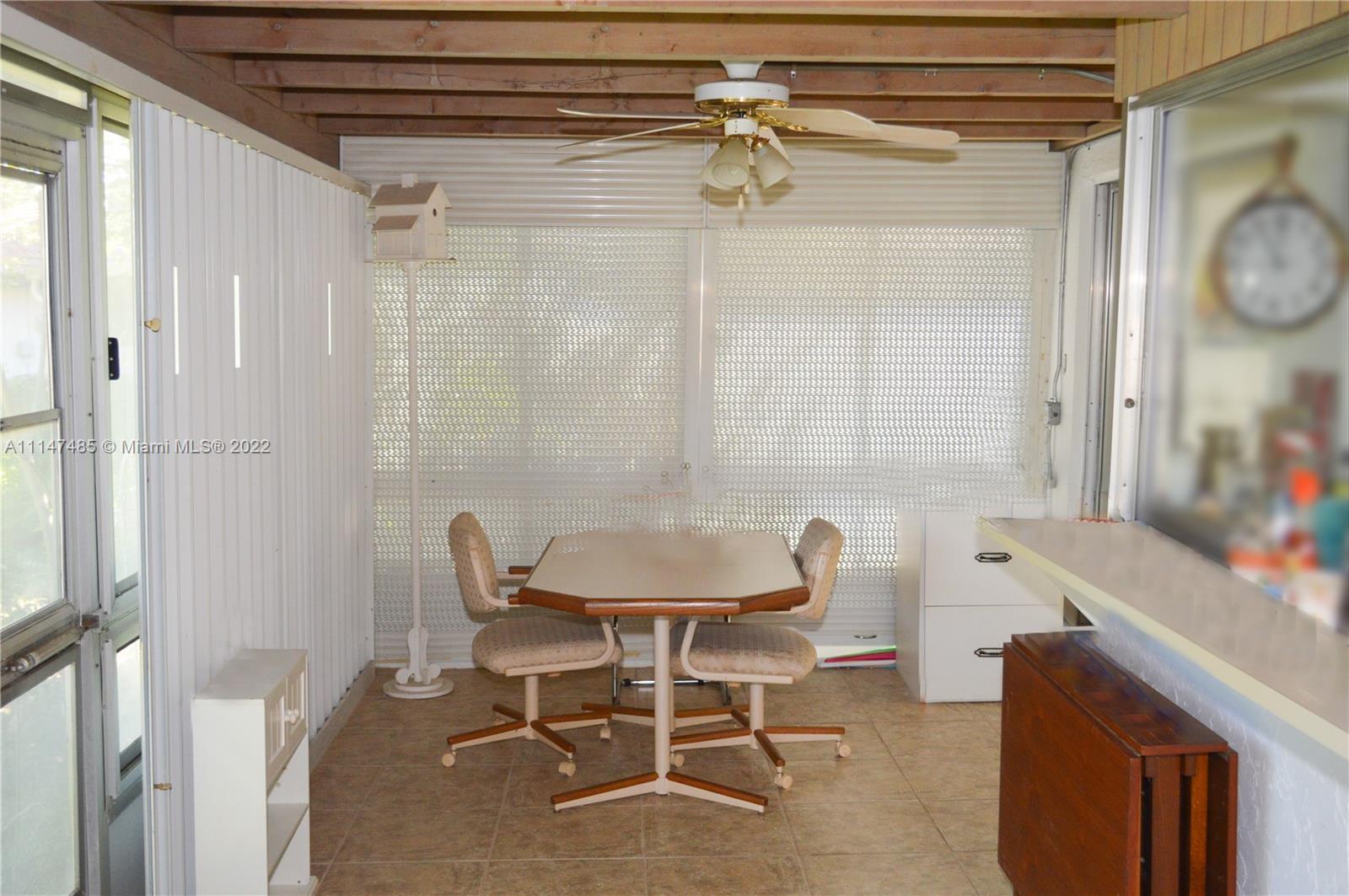 305 Northwest 42nd Street Boca Raton, FL 33431 - Photo 8 of 23 a view of a dining room with furniture and a window
