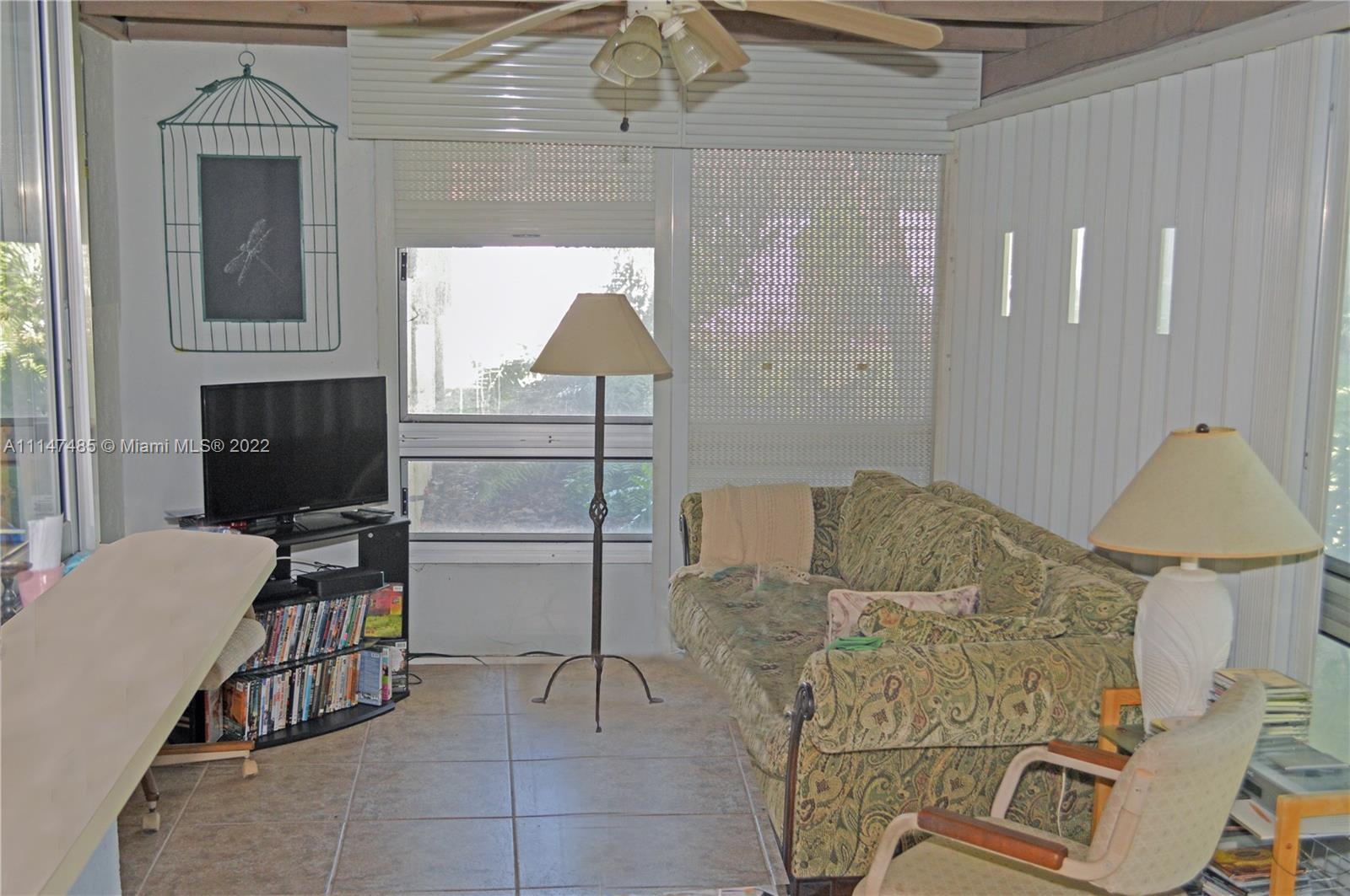305 Northwest 42nd Street Boca Raton, FL 33431 - Photo 9 of 23 a bedroom with furniture and a chair