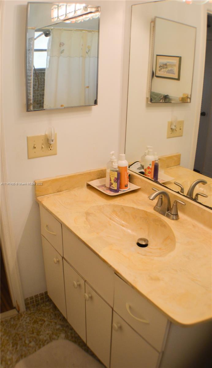 305 Northwest 42nd Street Boca Raton, FL 33431 - Photo 10 of 23 a bathroom with a sink and a mirror