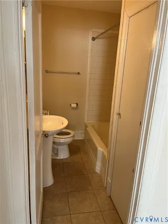a bathroom with a sink toilet and mirror
