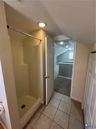 a bathroom with a toilet sink vanity granite and shower