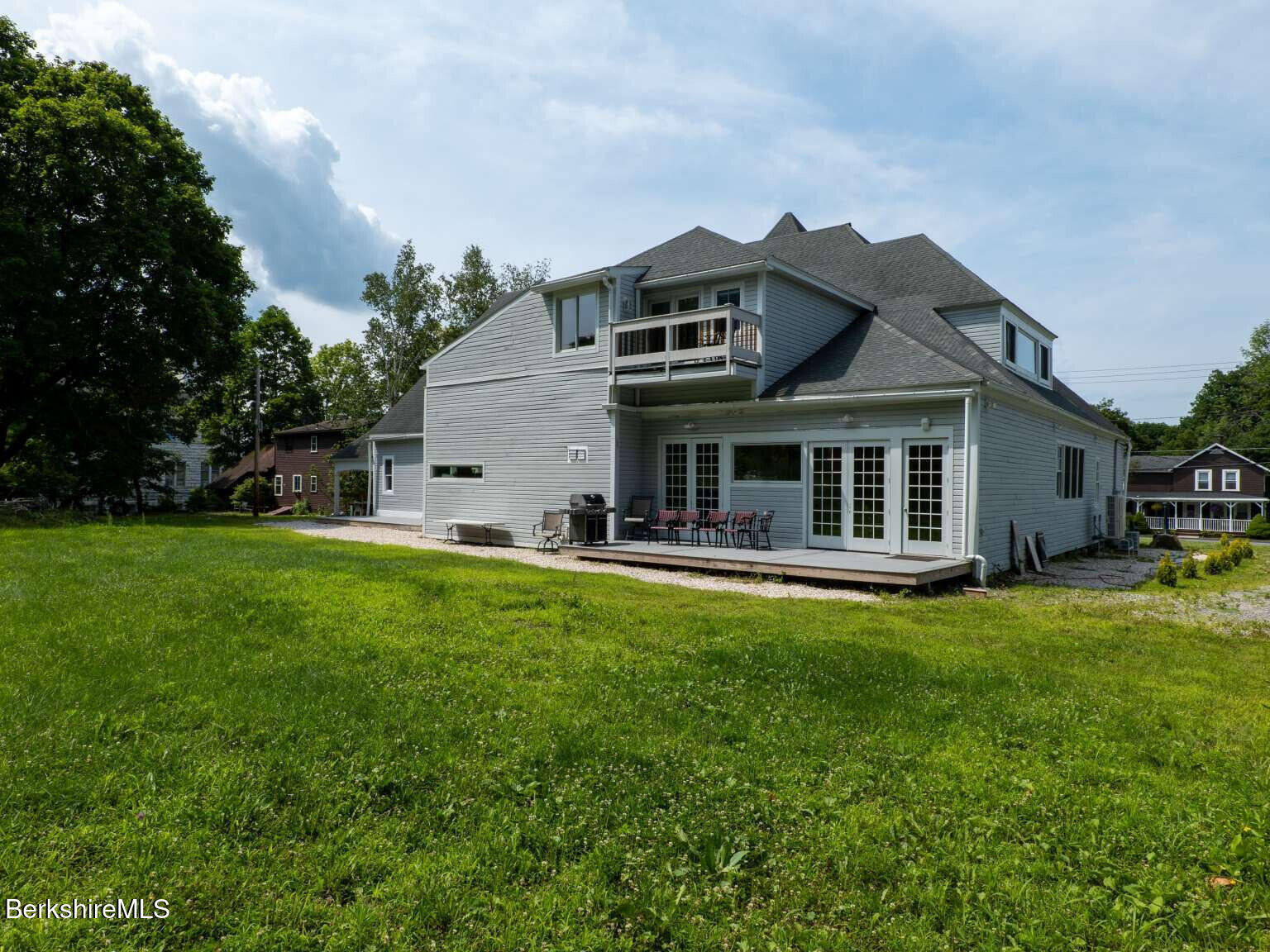 160 High Street Lee, MA 01238 - Photo 4 of 41 a view of a house with a yard and sitting area