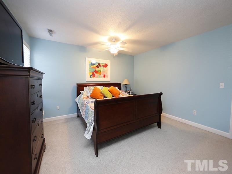 8512 Council Court Raleigh, NC 27615 - Photo 14 of 24 a bedroom with a bed and a flat screen tv