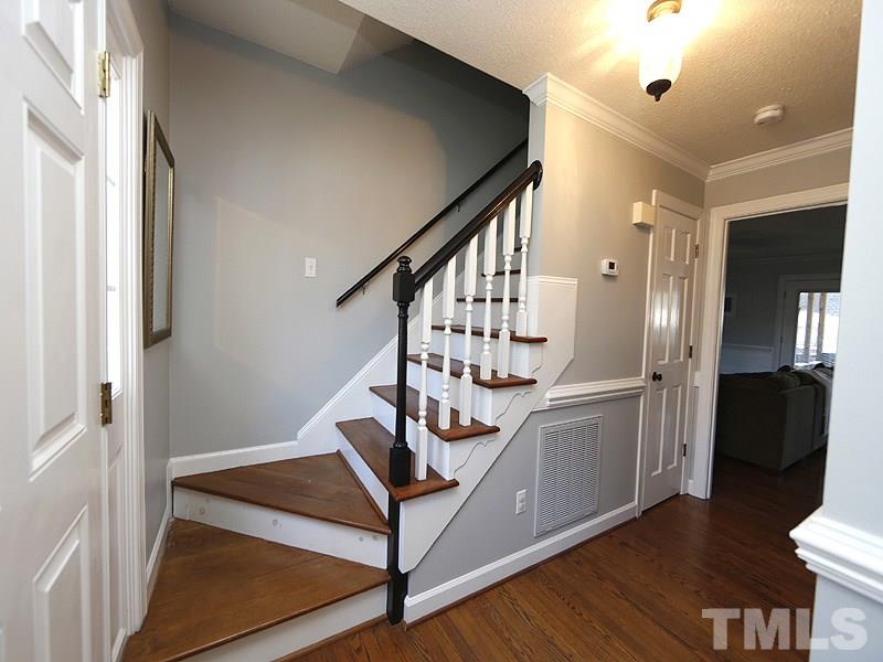 8512 Council Court Raleigh, NC 27615 - Photo 3 of 24 a view of entryway with wooden floor and stairs