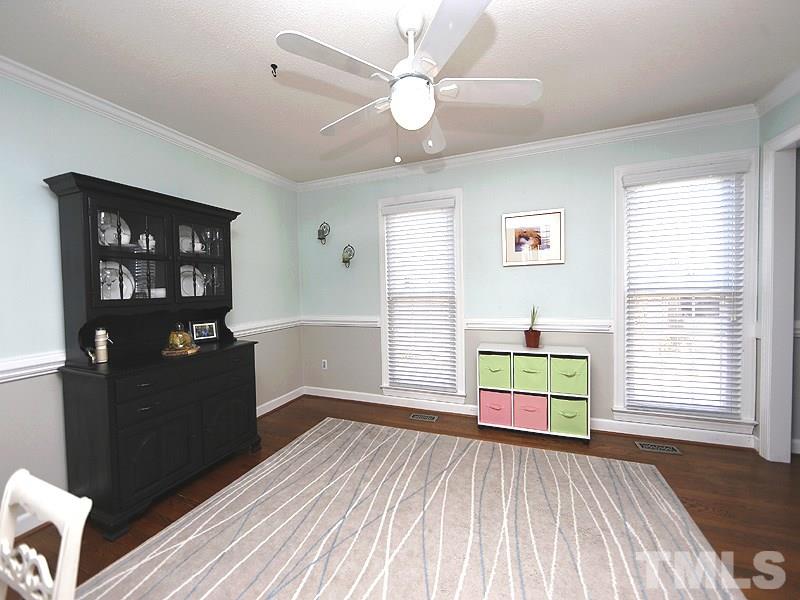 8512 Council Court Raleigh, NC 27615 - Photo 4 of 24 a bedroom with a bed and wooden floor