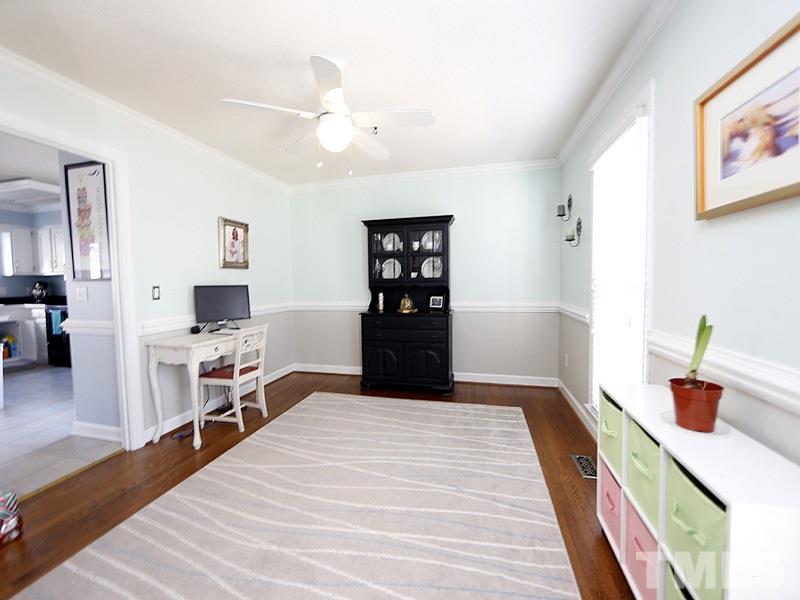 8512 Council Court Raleigh, NC 27615 - Photo 5 of 24 a bedroom with a bed and wooden floor