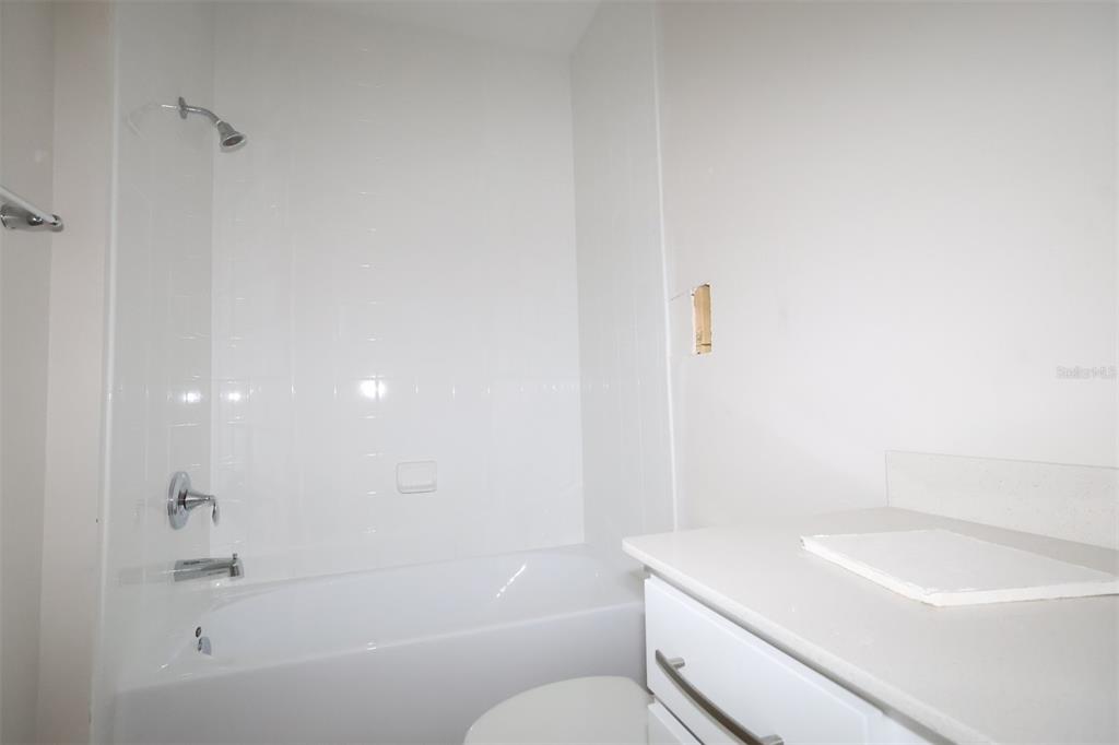 659 Pothos Street Apopka, FL 32703 - Photo 12 of 34 a bathroom with a sink a toilet and a bathtub