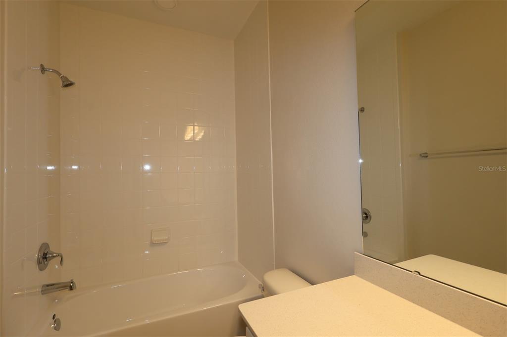 659 Pothos Street Apopka, FL 32703 - Photo 19 of 34 a bathroom with a bathtub and shower