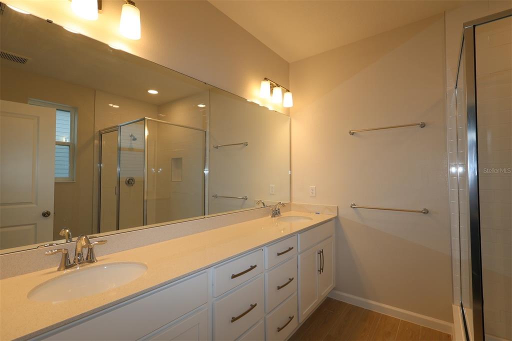 659 Pothos Street Apopka, FL 32703 - Photo 20 of 34 a bathroom with a double vanity sink and a mirror