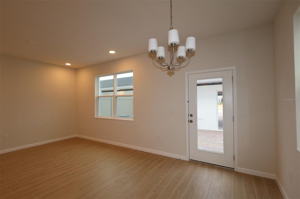 659 Pothos Street Apopka, FL 32703 - Photo 24 of 34 an empty room with wooden floor and windows