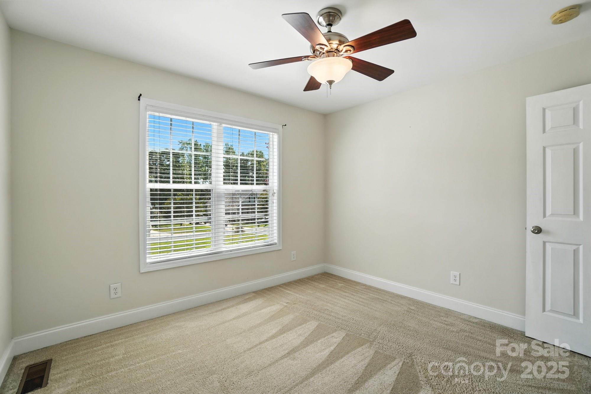708 Redah Avenue Locust, NC 28097 - Photo 28 of 48 an empty room with a window and a fan