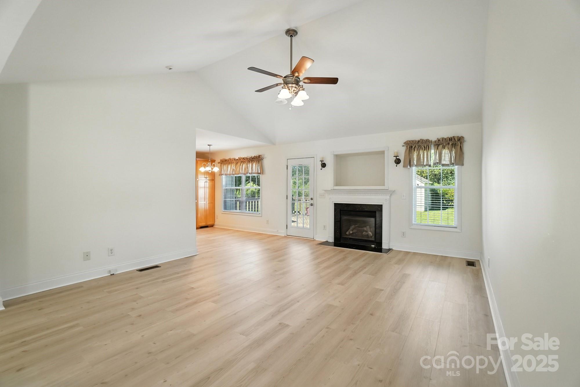 708 Redah Avenue Locust, NC 28097 - Photo 5 of 48 an empty room with windows and a fireplace