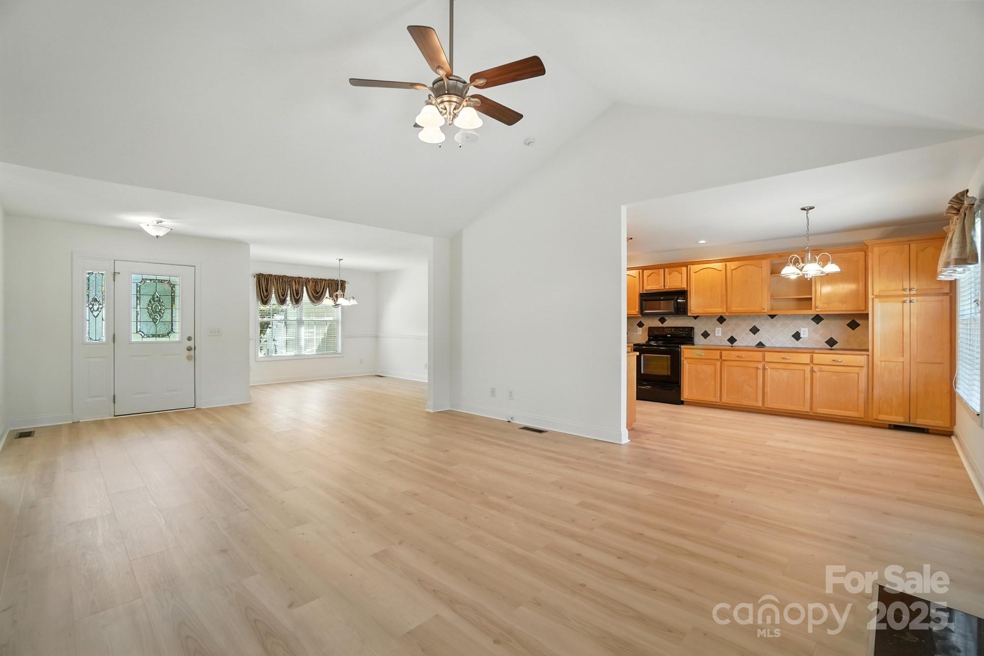 708 Redah Avenue Locust, NC 28097 - Photo 8 of 48 a view of an empty room with a window and wooden floor