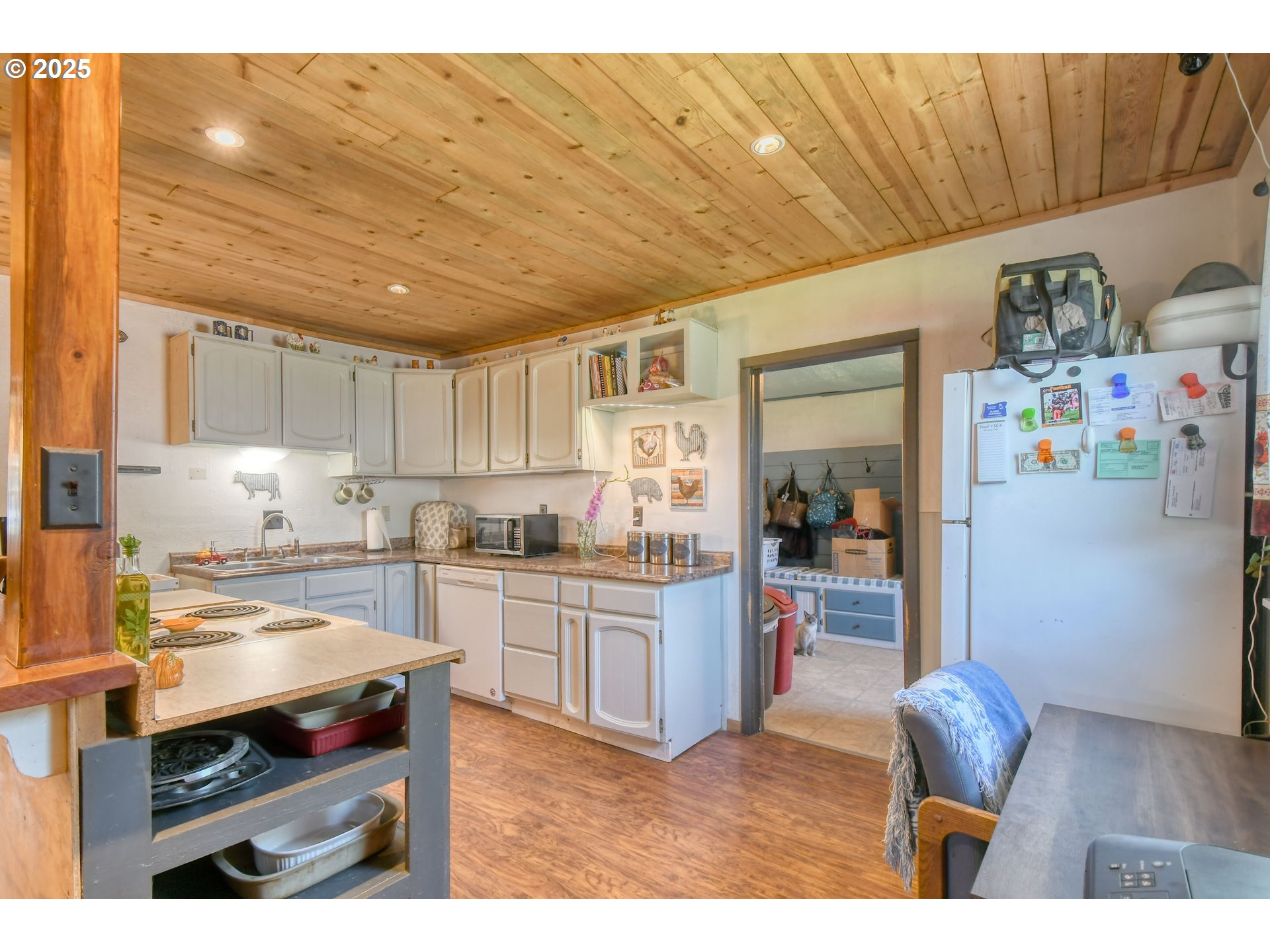 559 Southwest Cedar Street Pilot Rock, OR 97868 - Photo 16 of 42 a kitchen with stainless steel appliances kitchen island granite countertop a sink dishwasher stove and refrigerator with wooden cabinets
